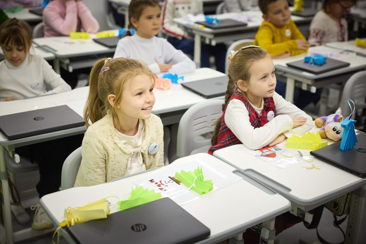 Students in a classroom with smartphones put away during a lesson, illustrating a study of phone bans and academic performance