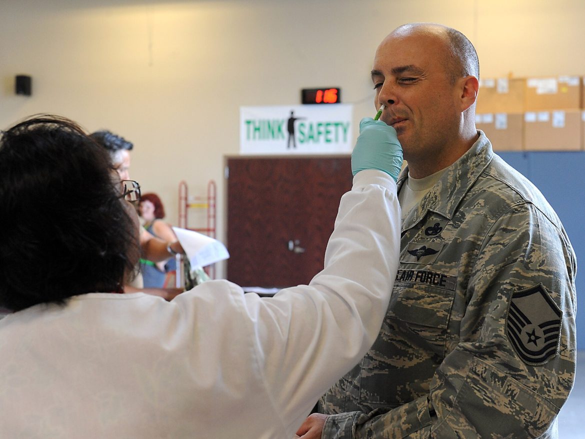 A healthcare worker preparing a measles vaccine dose, illustrating rising US measles cases and vaccination guidance